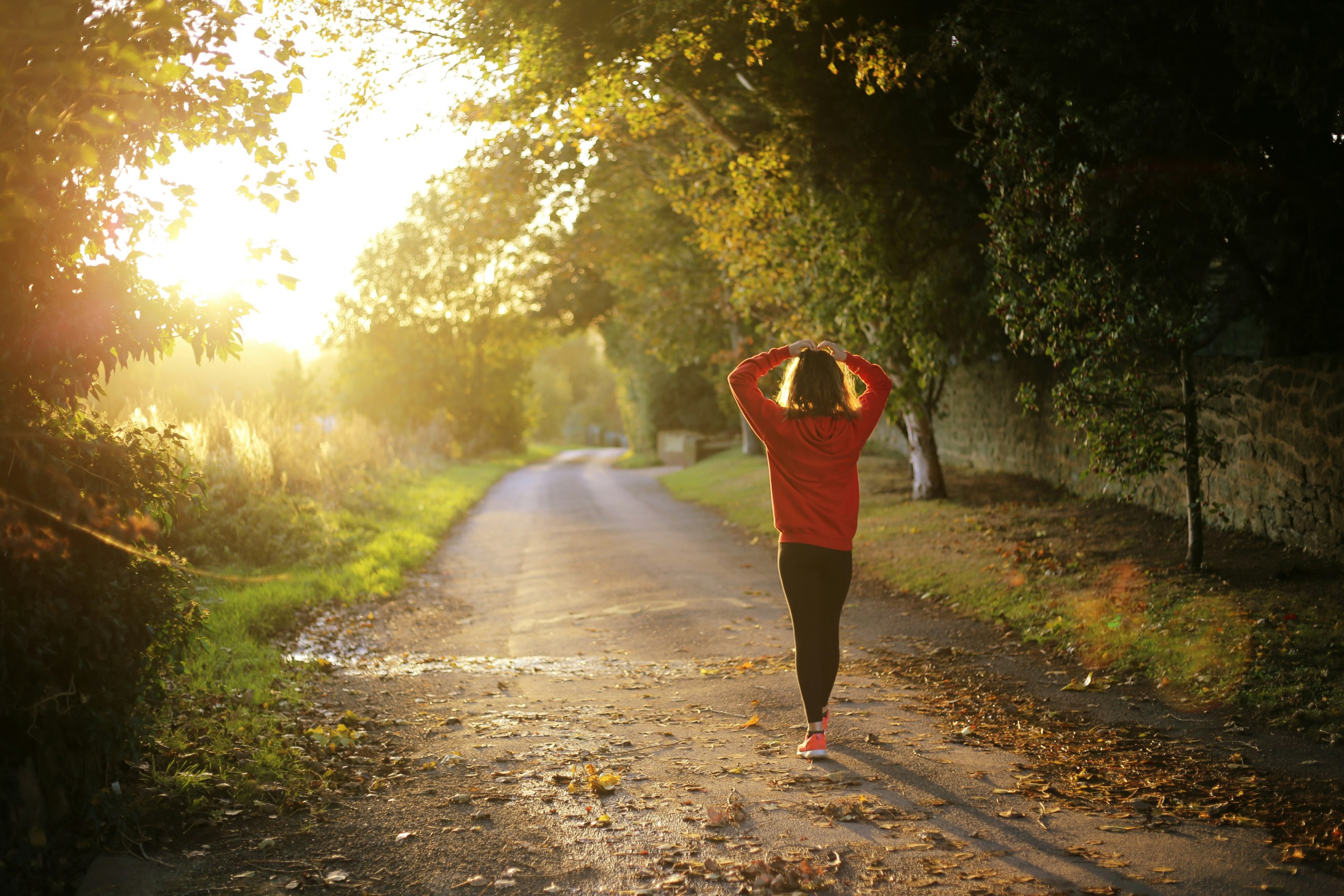 woman walking with hands over head