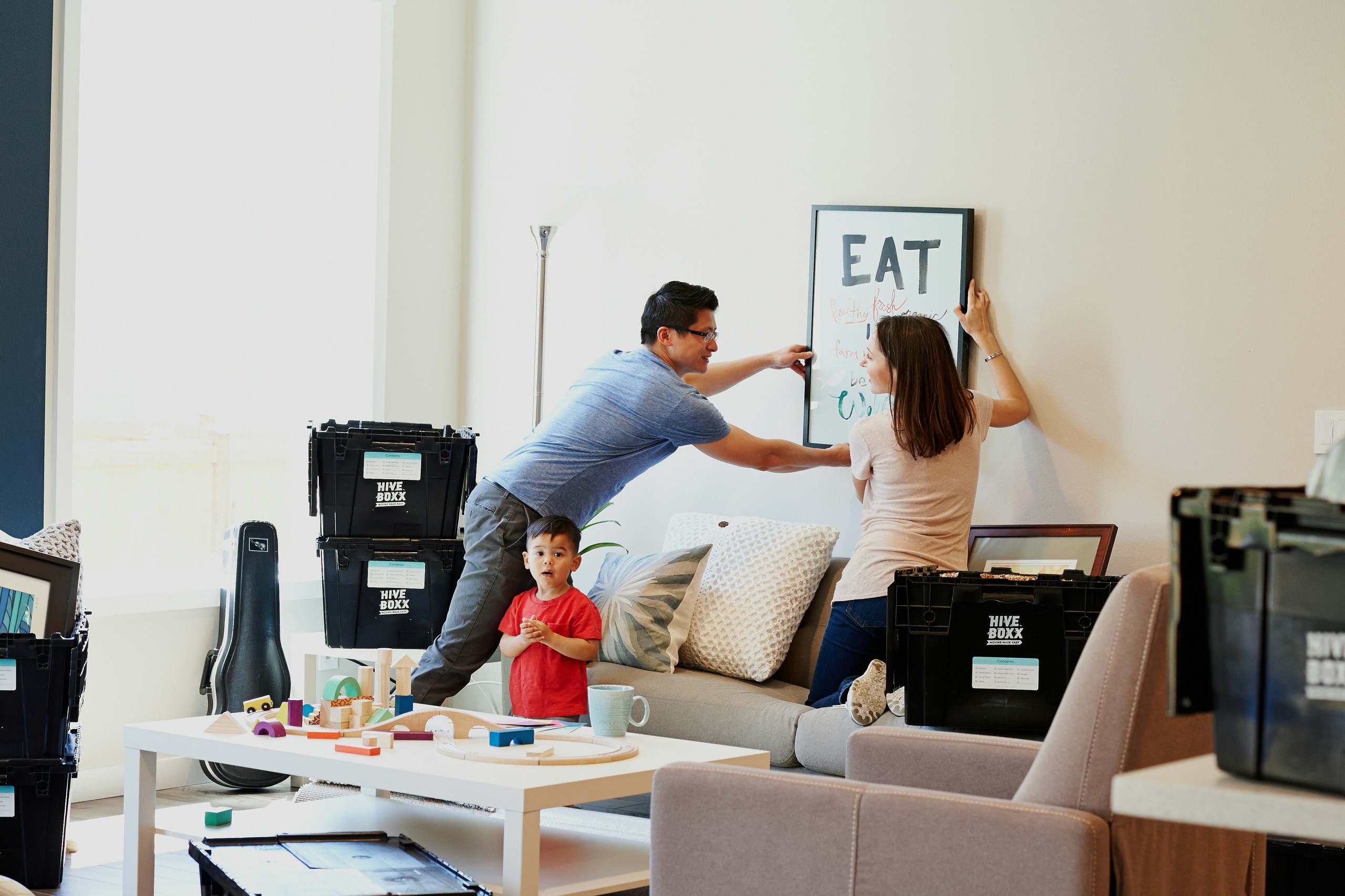 family hanging photo on wall