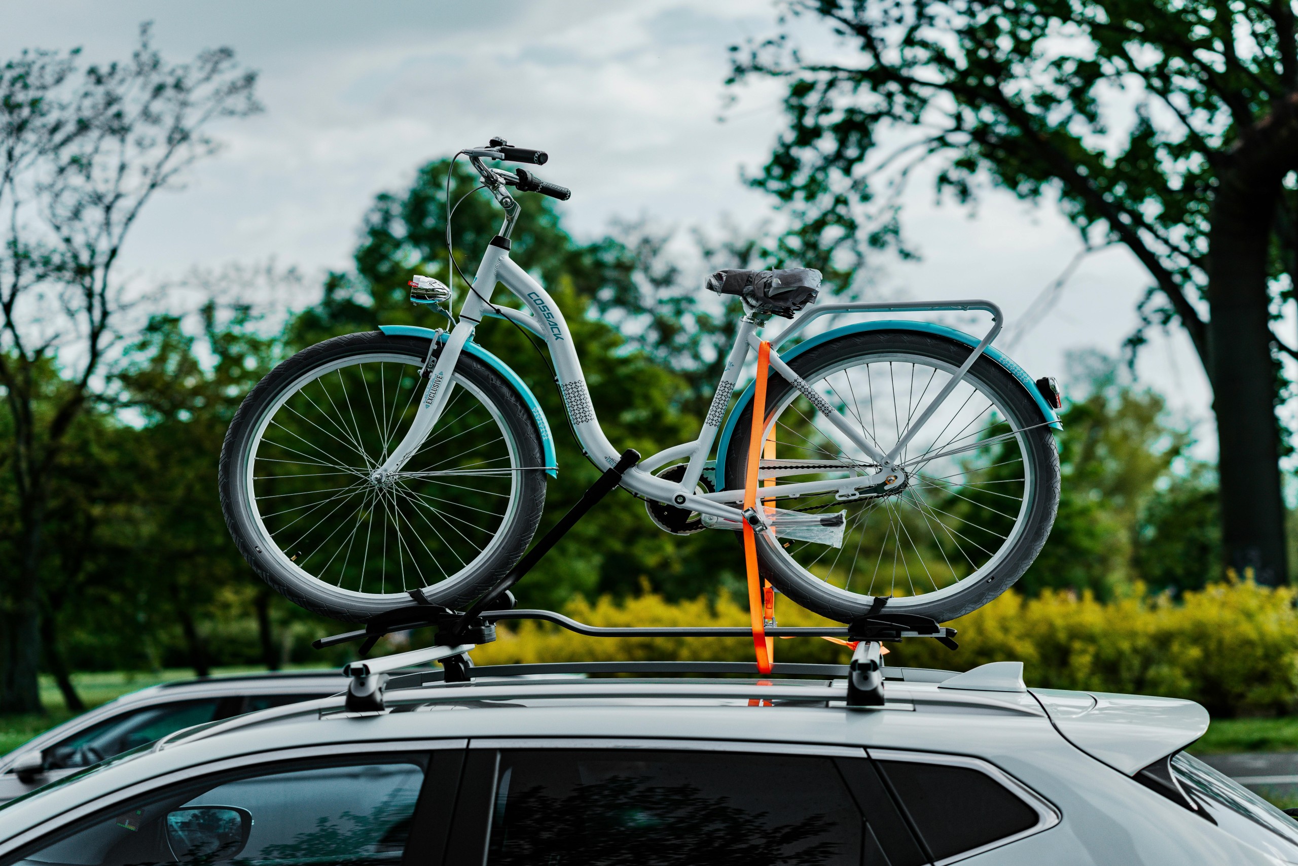 SUV with bicycle tied on top of roof